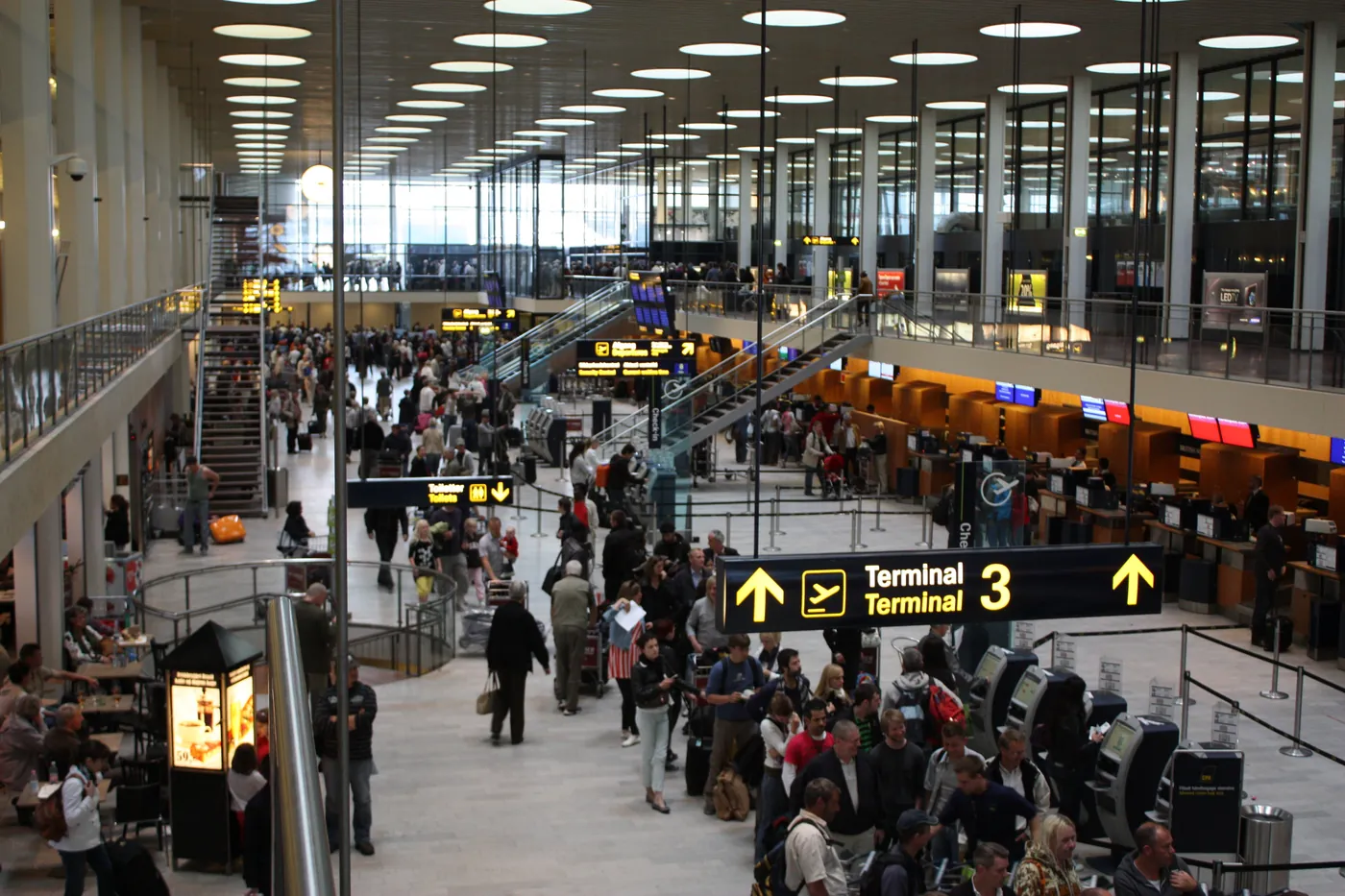 Arrivals area inside Copenhagen Airport where private drivers meet passengers